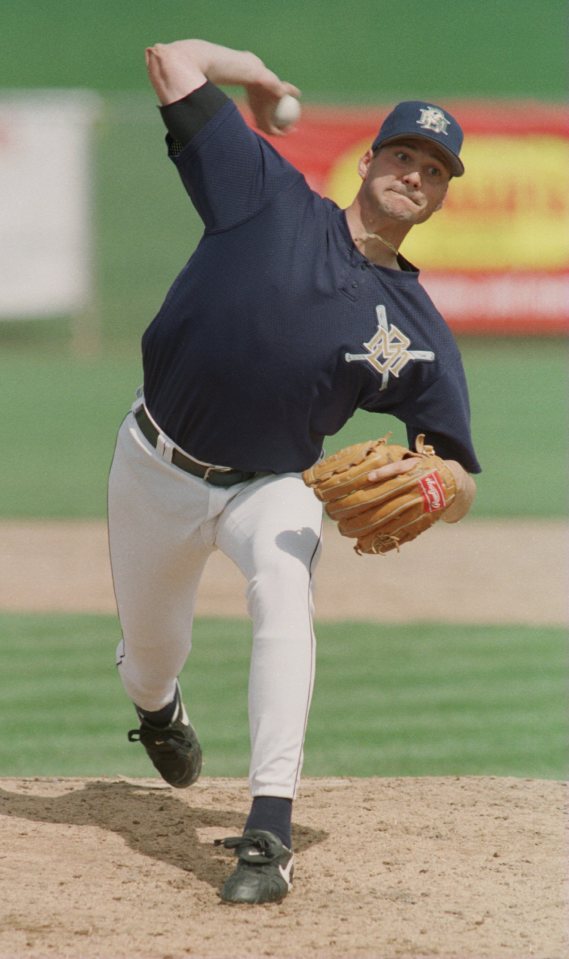 Ben McDonald, Milwaukee Brewers pitcher, pitching a baseball.