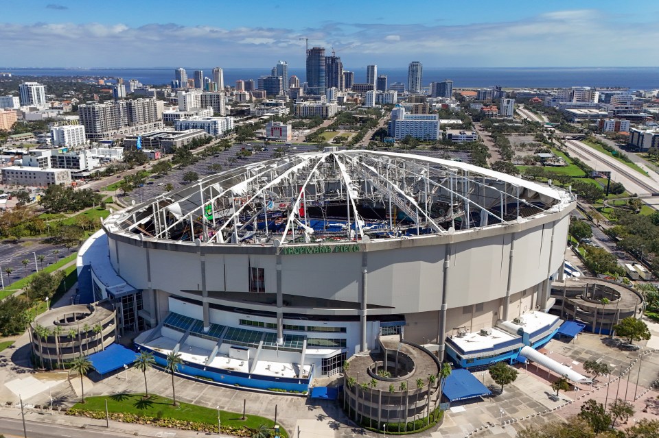 Aerial view of Tropicana Field with hurricane damage to its roof.