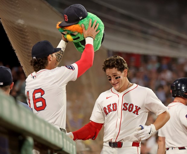 Jarren Duran (16) of the Boston Red Sox puts the Wally head on Roman Anthony after Anthony's two-run homer during the fifth inning of a MLB game against the Colorado Rockies at Fenway Park. (Photo By Matt Stone/Boston Herald)