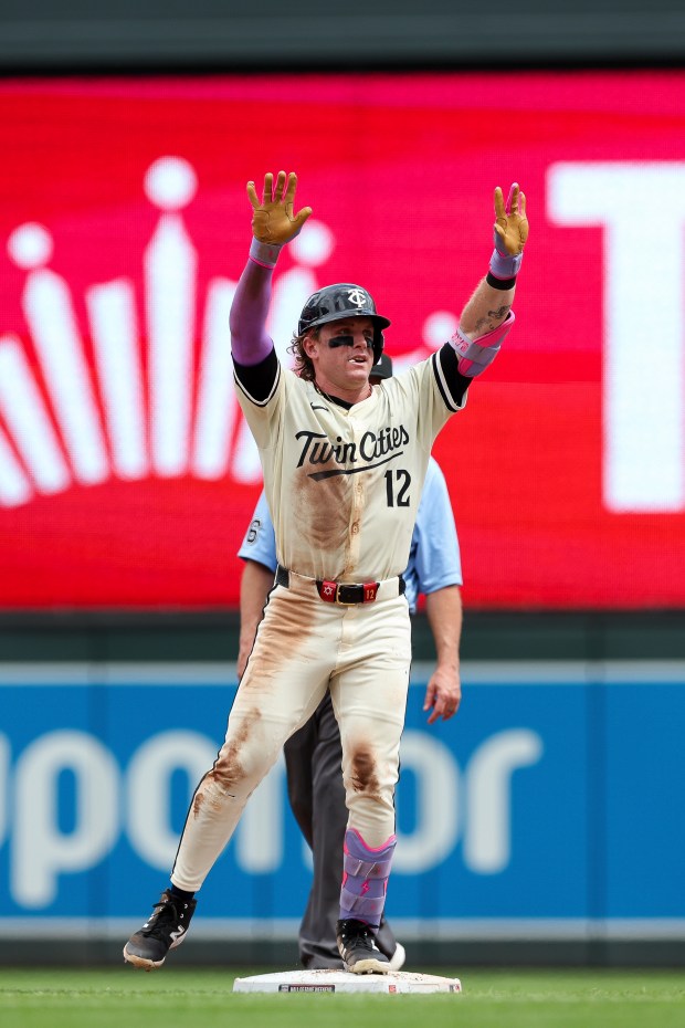 Minnesota Twins' Harrison Bader reacts after hitting a double against the Washington Nationals during the fifth inning of a baseball game Sunday, July 27, 2025, in Minneapolis. (AP Photo/Stacy Bengs)