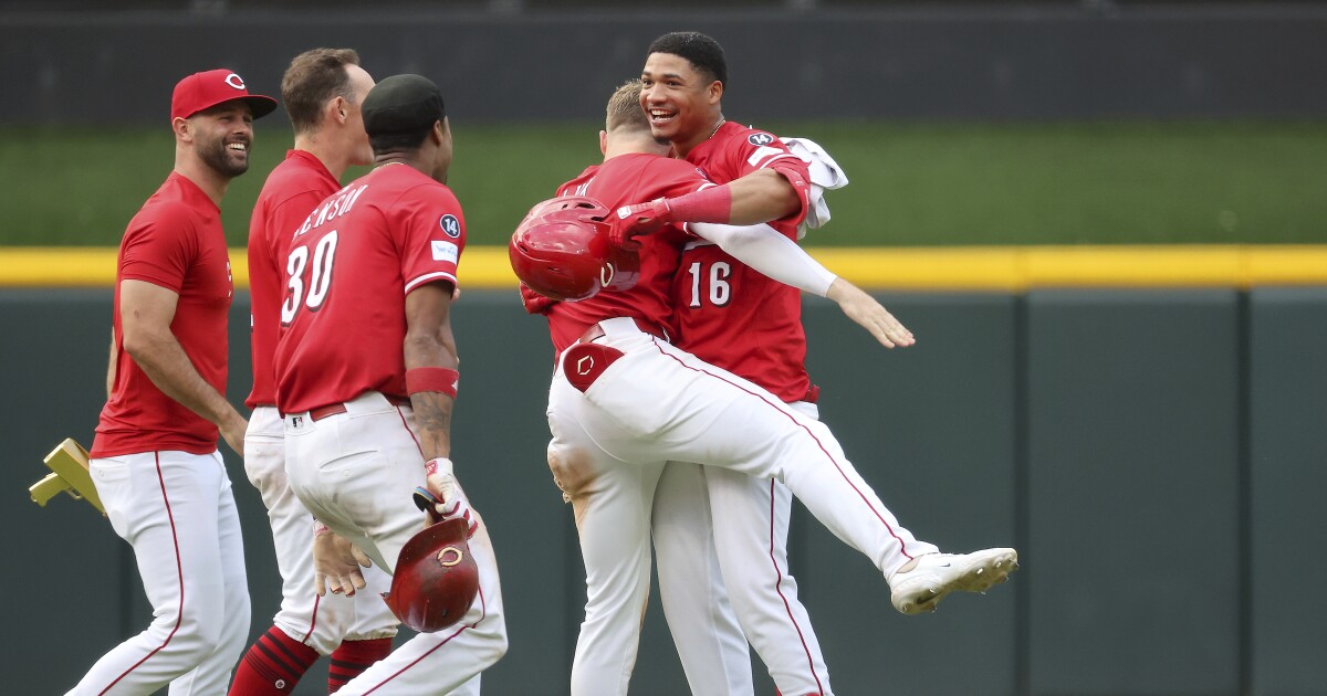 Benson triples and scores on 9th-inning error to left the Reds past the Rockies