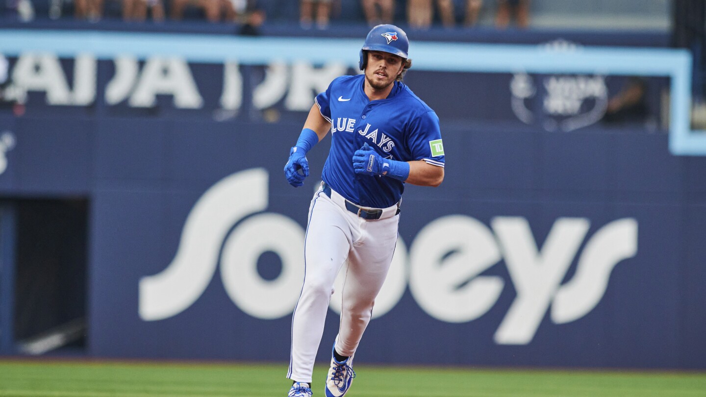 Blue Jays waste 8-run lead, then outlast Yankees 11-9 to tie New York for AL East lead