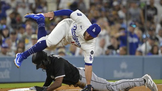 Los Angeles Dodgers third baseman Max Muncy (13) is injured as he flips over Chicago White Sox right fielder Michael A. Taylor (21) after tagging him out on an attempted steal in the fifth inning at D... Los Angeles Dodgers third baseman Max Muncy (13) is injured as he flips over Chicago White Sox right fielder Michael A. Taylor (21) after tagging him out on an attempted steal in the fifth inning at D...