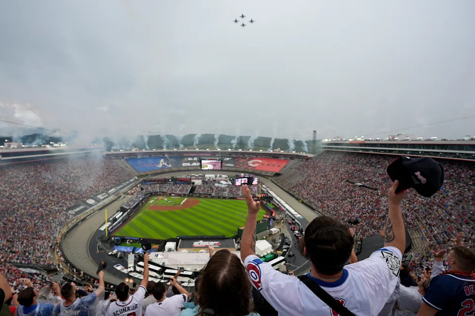Fans cheer during a flyover before the MLB Speedway Classic baseball game between the Atlanta Braves and the Cincinnati Reds at Bristol Motor Speedway in Bristol, Tenn., Saturday, Aug. 2, 2025. (AP Photo/George Walker IV)
