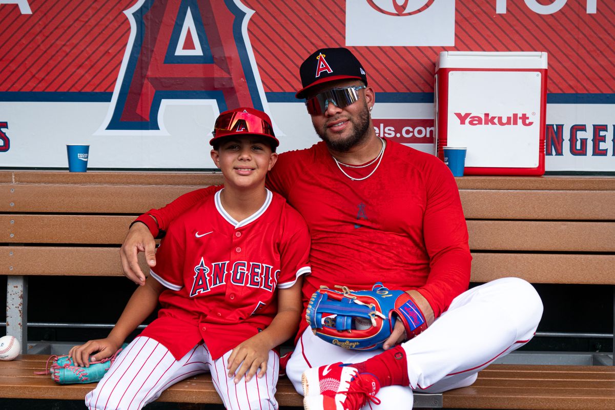 Los Angeles Angels Infielder Yoan Moncada (5) spends time with fan before an MLB game against the Cincinnati Reds, Wednesday, August 20, 2025 at Angels Stadium in Anaheim, California.