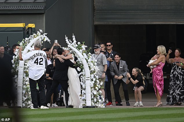 White Sox fans kiss after exchanging wedding vows during a 60-second wedding