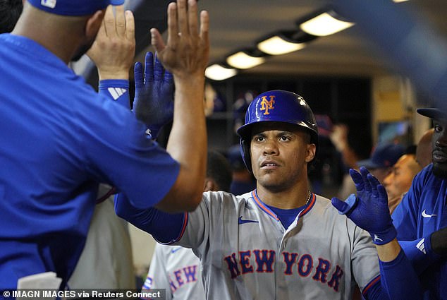 New York Mets outfielder Juan Soto (22) celebrates in the dug out after hitting a home run