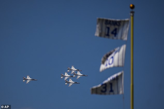The United States Air Force Thunderbirds fly over Wrigley Field as they practice for the Chicago Air and Water Show during the fourth inning of a Cubs-Pirates game on Friday