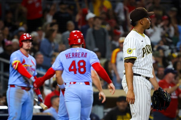 Padres relief pitcher Jeremiah Estrada looks on as Cardinals players celebrate following a two-run double in the fifth inning Saturday. (Meg McLaughlin / The San Diego Union-Tribune)