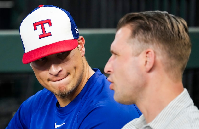 Texas Rangers pitcher Robert Garcia talks with general manager Ross Fenstermaker in the...