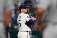 Texas Rangers starting pitcher Jack Leiter stands on the mound waiting to be pulled in the...