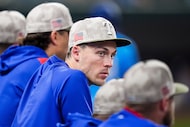Texas Rangers outfielder Evan Carter watches from the dugout during the eighth inning of a...