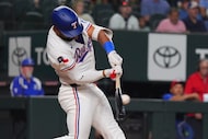 Texas Rangers' Ezequiel Duran hits a single that scored teammates Josh Jung and Josh Smith...