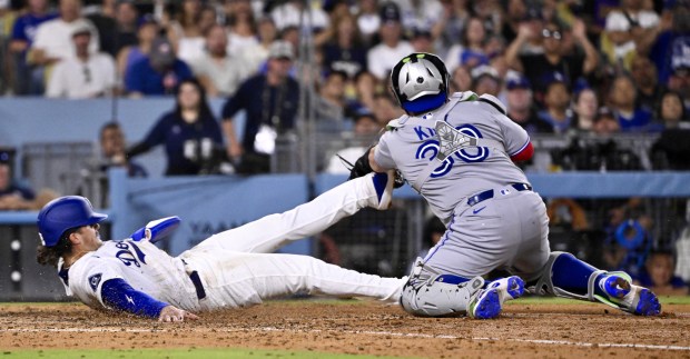 Alex Freeland #76 of the Dodgers safe at home plate...