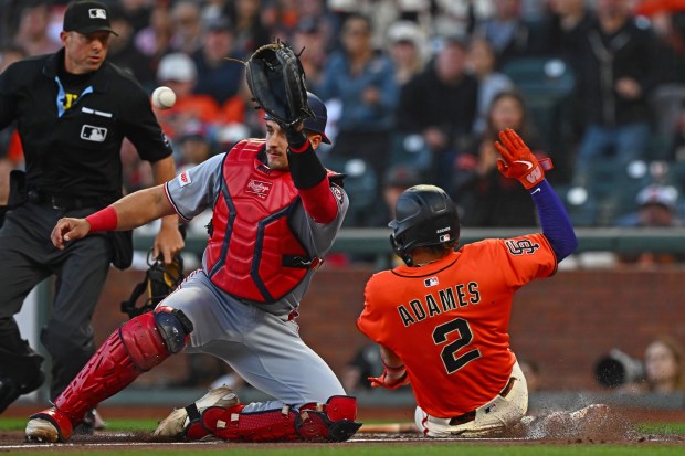 San Francisco Giants' Willy Adames (2) scores at home plate as Washington Nationals catcher Drew Millas (81) waits for the throw in the first inning of their MLB game at Oracle Park in San Francisco, Calif., on Friday, Aug. 8, 2025. (Jose Carlos Fajardo/Bay Area News Group)