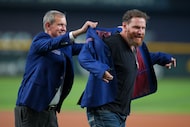 Former Texas Rangers outfielder Josh Hamilton, right, gets helped by Rangers senior...