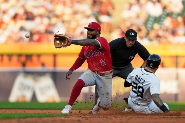 Detroit Tigers’ Javier Baez, right, steals second against Angels second...