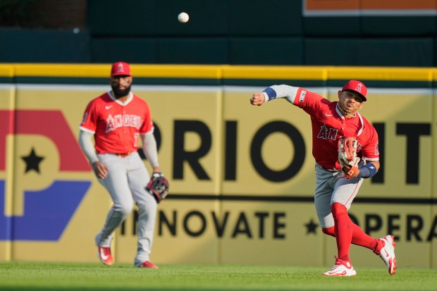 Angels right fielder Gustavo Campero, right, attempts to throw out...