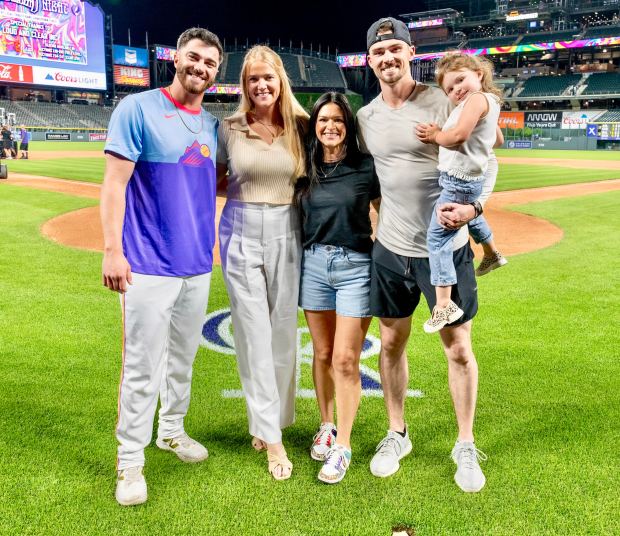 From left to right, Rockies rookie reliever Dugan Darnell, his fiancée Emily Tatge, Shelby Rose Doyle, Rockies center fielder Brenton Doyle, and daughter Braelynn Doyle pose after the Rockies' 17-16 win over the Pirates on Aug. 1, 2025, at Coors Field. (Courtesy of Emily Tatge)