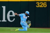 Texas Rangers right fielder Adolis Garcia bobbles a fly out by Philadelphia Phillies' Nick...