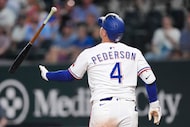 Texas Rangers designated hitter Joc Pederson tosses his bat after striking out during the...