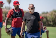 Rehab pitching coordinator Keith Comstock works with players at the Texas Rangers practice...