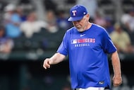 Texas Rangers manager Bruce Bochy heads back to the dugout after a pitching change during...
