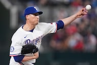 Texas Rangers relief pitcher Robert Garcia delivers during the seventh inning of a baseball...