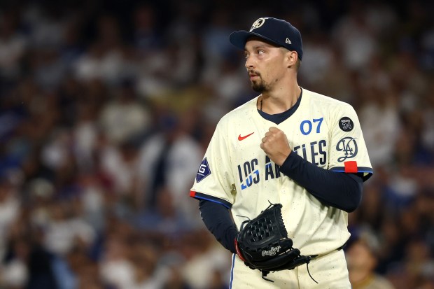 Dodgers starting pitcher Blake Snell reacts after an out during...