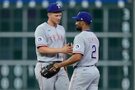 Texas Rangers shortstop Corey Seager (5) and second baseman Marcus Semien (2) celebrate...
