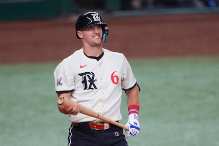 Texas Rangers' Josh Jung reacts after taking a swing at a pitch during an at-bat in a...