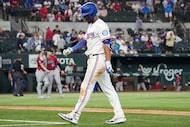 Texas Rangers second baseman Marcus Semien heads to the dugout after lining out for the...
