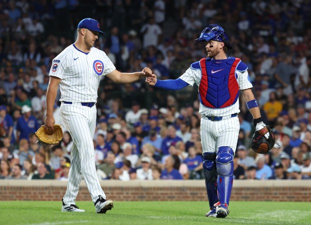 Chicago Cubs starting pitcher Jameson Taillon and catcher Carson Kelly congratulate one another after shutting down the Milwaukee Brewers in the second inning of Game 2 of a doubleheader at Wrigley Field in Chicago on Aug. 19, 2025. (Chris Sweda/Chicago Tribune)