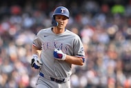 Texas Rangers' Corey Seager rounds the bases after hitting a solo home run against the...