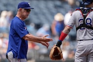 Texas Rangers manager Bruce Bochy walks to the mound to make a pitching change during the...