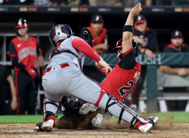 Minnesota Twins catcher Ryan Jeffers tags out Chicago White Sox third baseman Miguel Vargas at home plate as Vargas tried to score after a pop foul to end the eighth inning at Rate Field in Chicago on Aug. 22, 2025.  (Chris Sweda/Chicago Tribune)