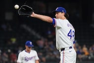 Texas Rangers starting pitcher Jacob deGrom gets a new hame ball during the fifth inning of...