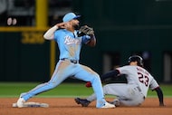 Texas Rangers' Ezequiel Duran looks to first after forcing Cleveland Guardians' Bo Naylor...