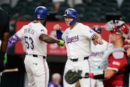 Texas Rangers' Adolis Garcia (53) and Wyatt Langford, center, celebrate Garcia's three-run...