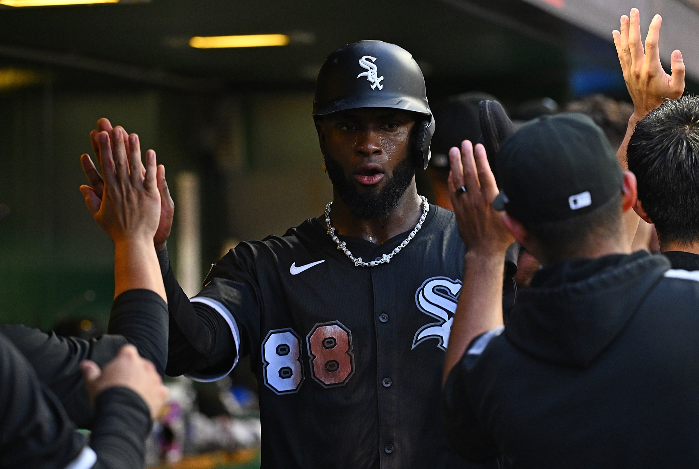Luis Robert Jr. #88 of the Chicago White Sox celebrates with teammates in the dugout after coming around to score on a three run RBI double by Mike Tauchman #18 (not pictured) in the sixth inning during the game against the Pittsburgh Pirates at PNC Park on July 19, 2025 in Pittsburgh, Pennsylvania.