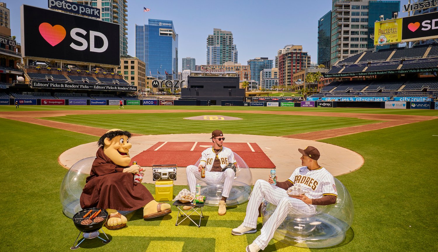 San Diego Padres baseball players Manny Machado and Jackson Merrill having a BBQ with the Friar at Petco Park for San Diego Magazine's 2025 Best of Issue cover