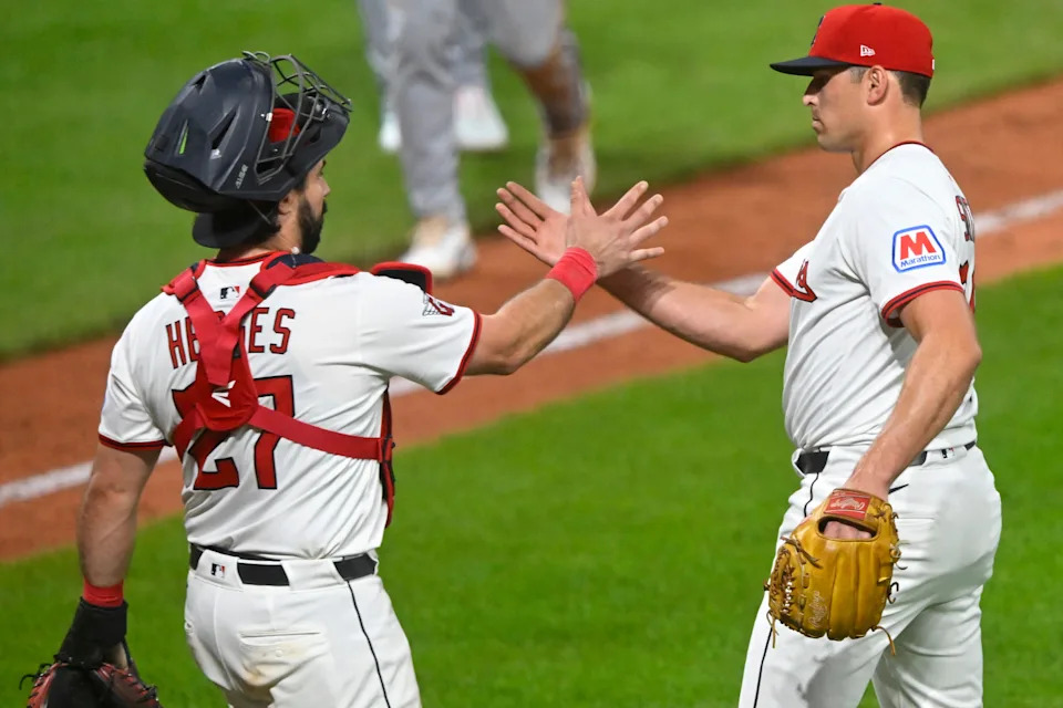 Cleveland Guardians catcher Austin Hedges (27) and relief pitcher Cade Smith celebrate a win over the Miami Marlins on Aug. 14, 2025, in Cleveland.
