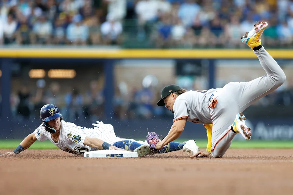 Willy Adames of the San Francisco Giants tags out Milwaukee's Sal Frelick, who was attempting to steal second base in the first inning on Aug. 23.