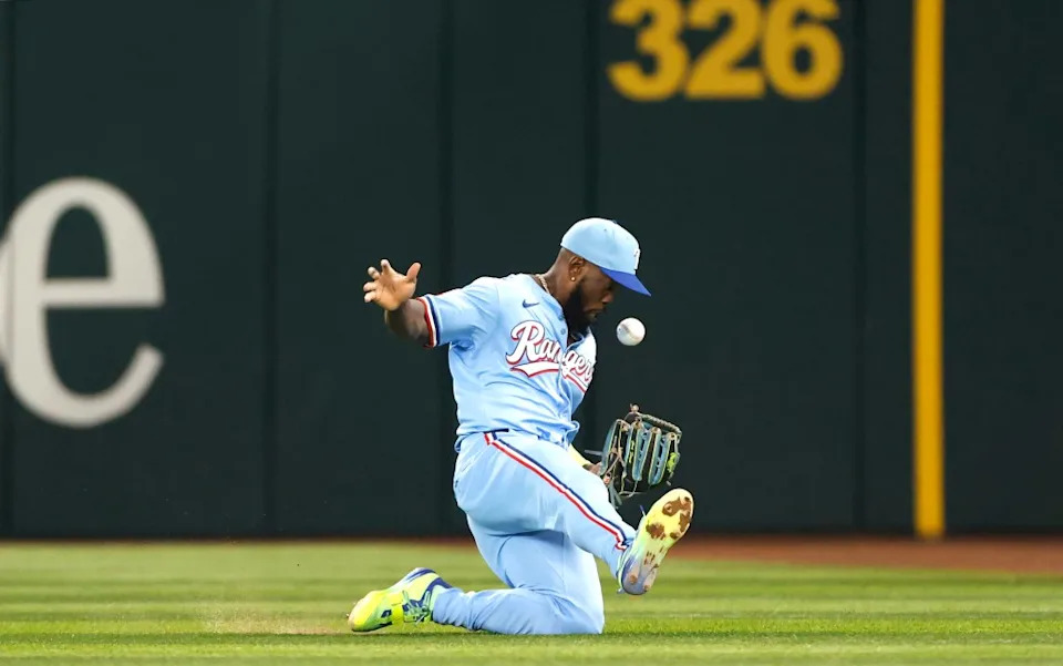 Adolis García juggles and then catches a fly ball off the bat of Nick Castellanos of the Phillies during the second inning at Globe Life Field on August 10, 2025 in Arlington, Texas. Getty Images