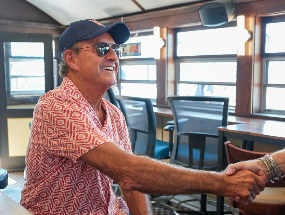 Former Red Sox outfielder Fred Lynn shakes hands and signs photos inside Sherwood’s Diner at Polar Park August 7.
