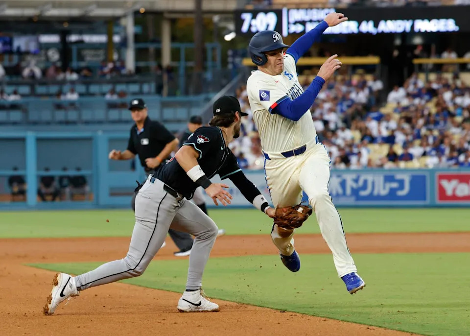 Dodgers baserunner Freddie Freeman is tagged out by Arizona third baseman Blaze Alexander.