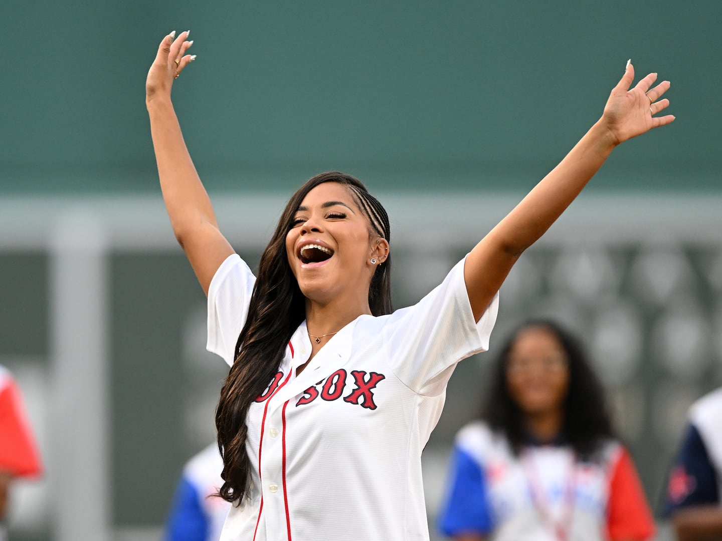 Amaya Espinal of Love Island reacts after a ceremonial pitch before a game between the Kansas City Royals and the Boston Red Sox. 