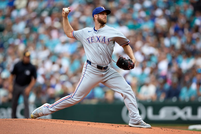 Texas Rangers starting pitcher Merrill Kelly throws against the Seattle Mariners during the...