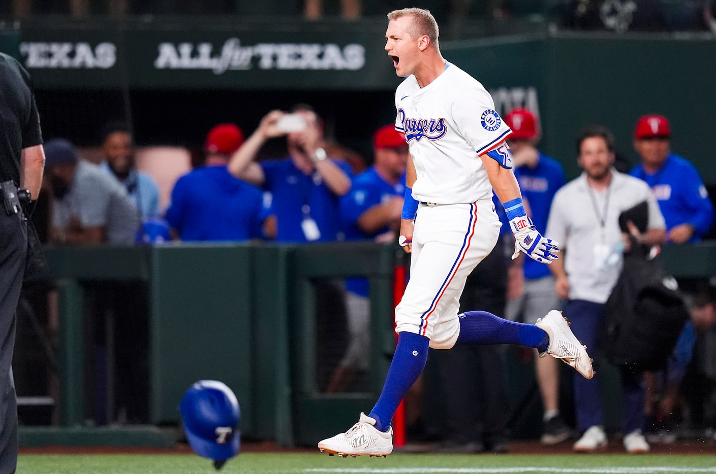 Texas Rangers designated hitter Josh Jung celebrates as he rounds the bases after hitting a...