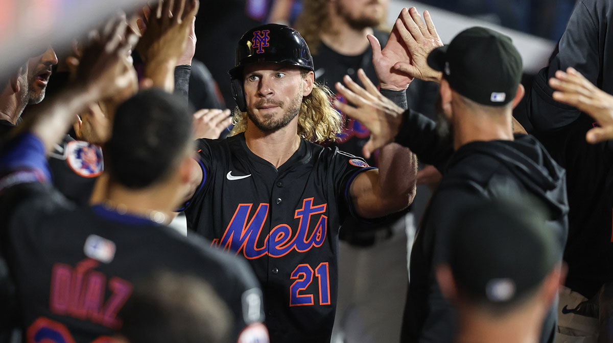 New York Mets center fielder Travis Jankowski (21) is greeted in the dugout after scoring a run as a pinch hitter in the eighth inning against the Milwaukee Brewers at Citi Field. 